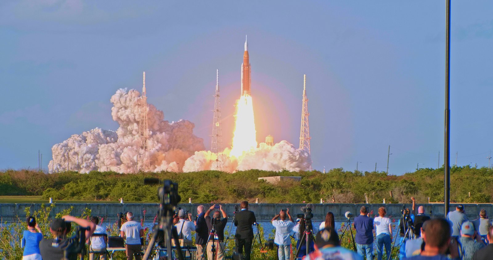 Spectators watch the Artemis II rocket lift off